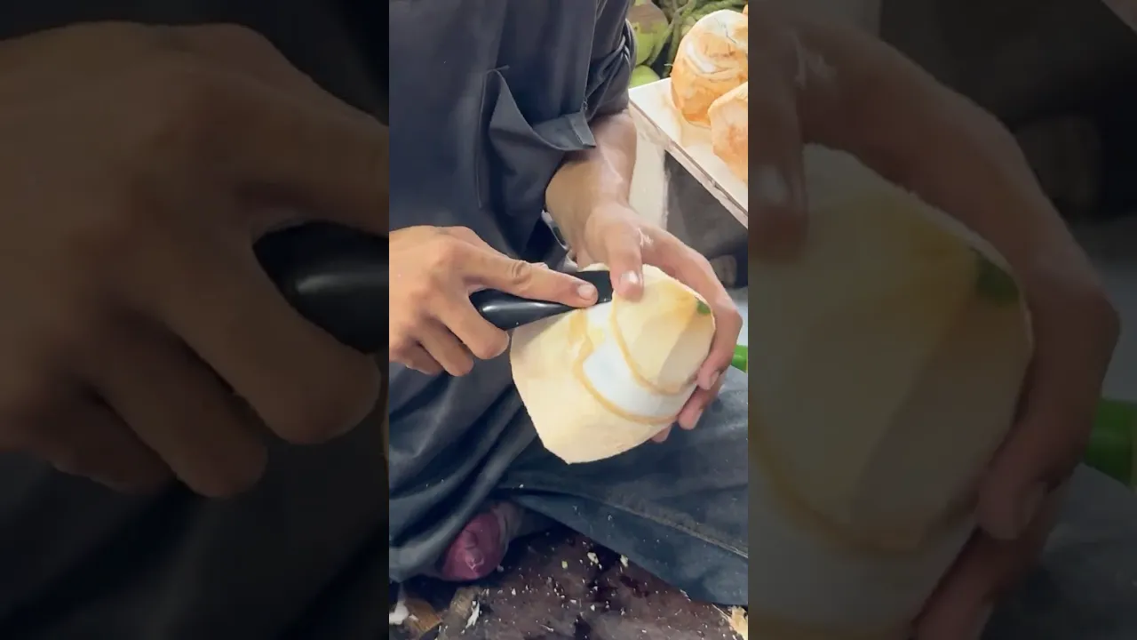 Traditional Coconut Peeling Skills by a Young Thai Boy in Bangkok
